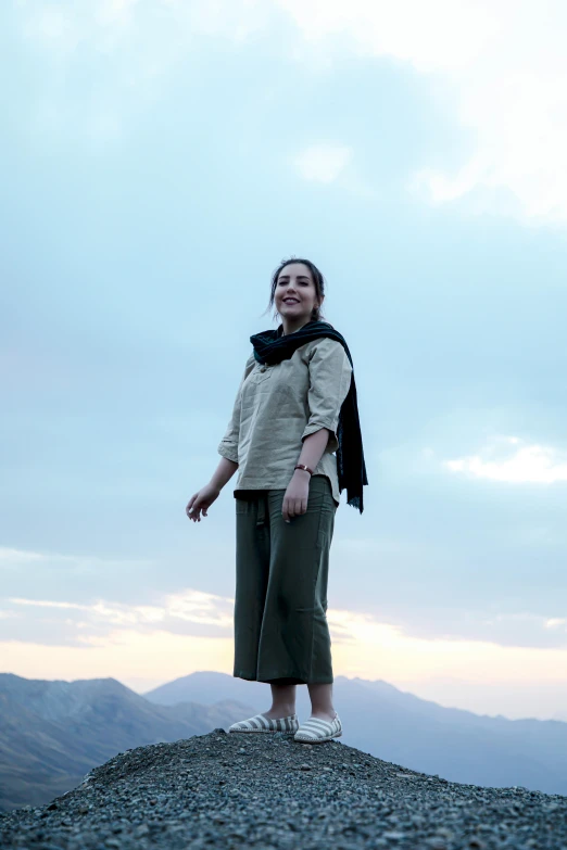 a person on top of a hill posing for the camera