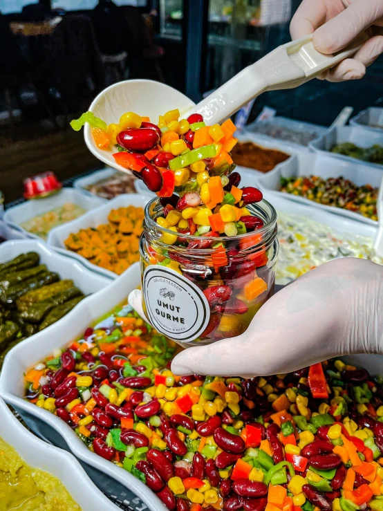 a person mixing up candy in a bowl