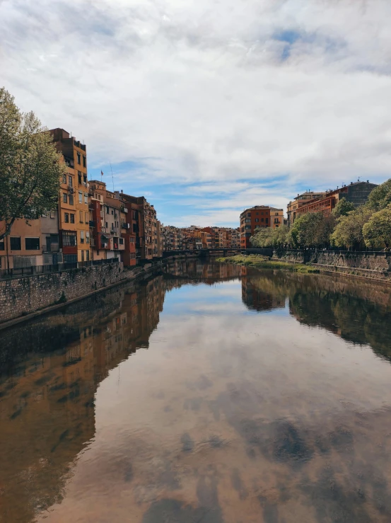 the calm river runs through a city with houses