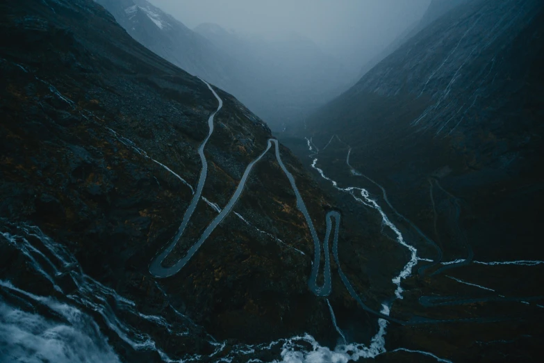 two curved roads going down a steep mountain