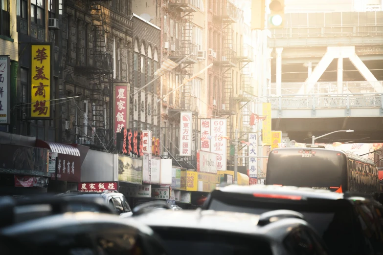 traffic is driving down a city street lined with tall buildings