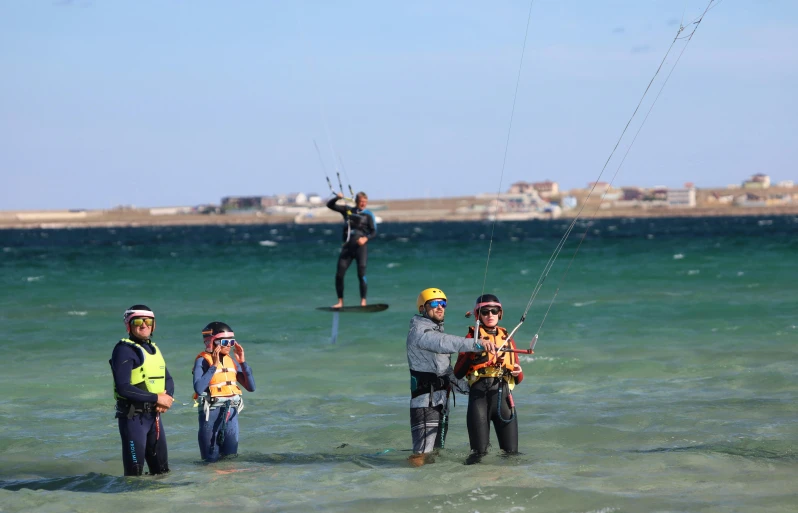 people in the water getting ready to parasail