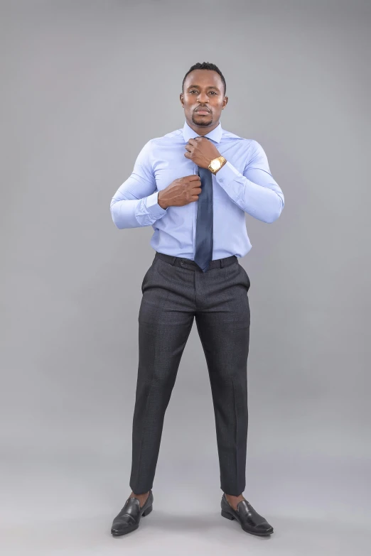 a man wearing a blue shirt and grey tie