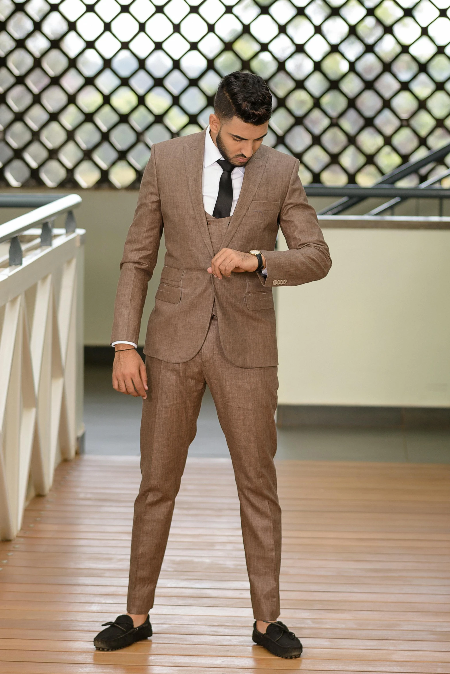 a man in a suit standing on top of a wooden floor