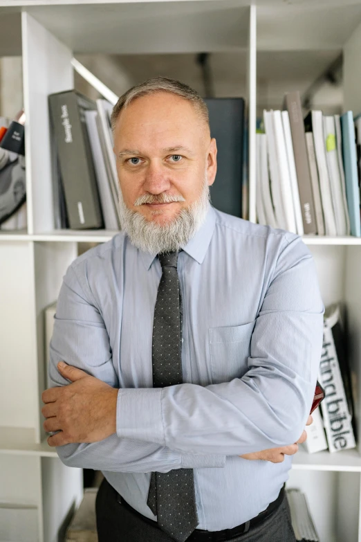 a man in tie and dress shirt looking at the camera