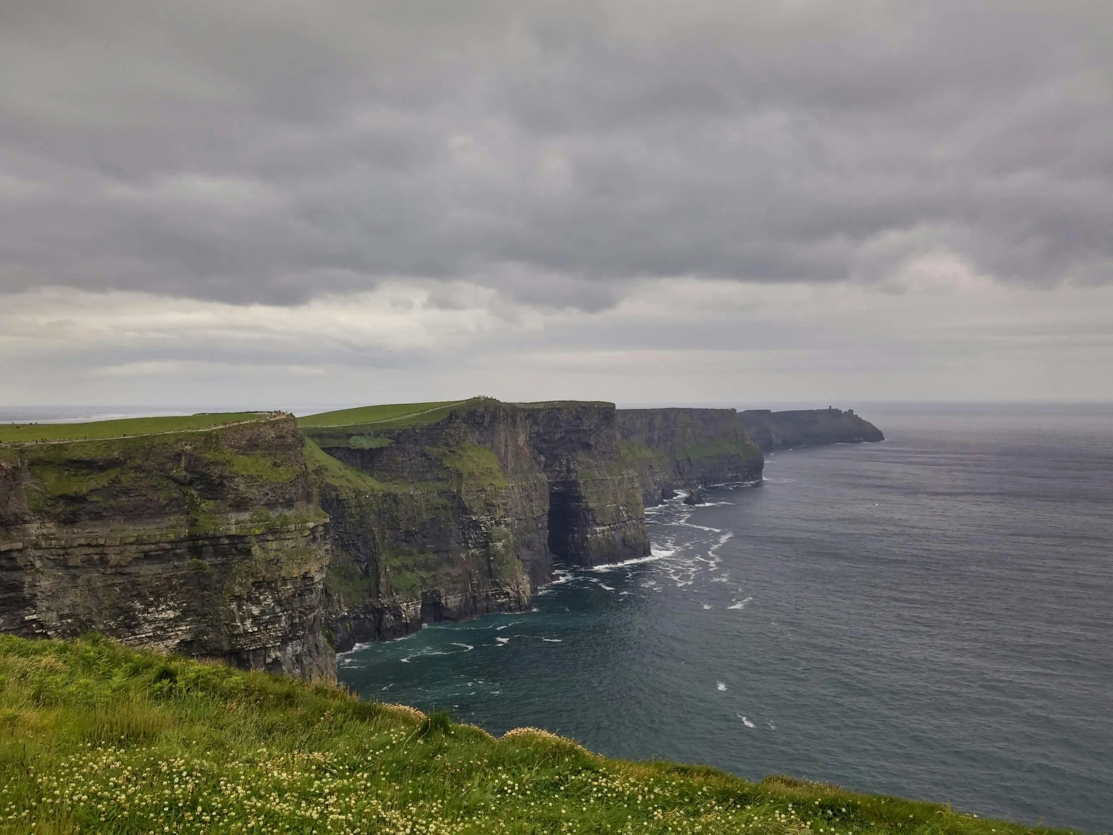 the cliffs are steep to the ocean and grassy shore