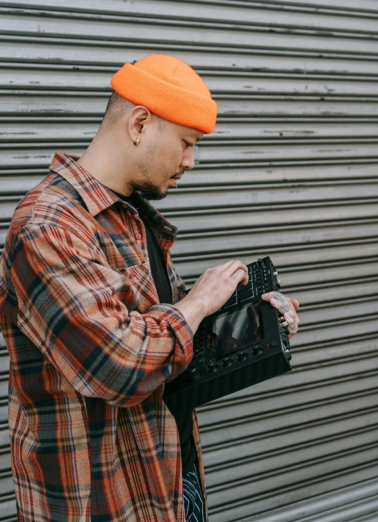 a man standing on the sidewalk holding a bag