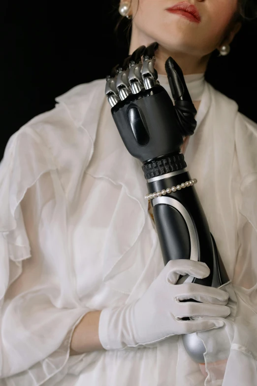 a woman is holding onto the top of a robotic arm