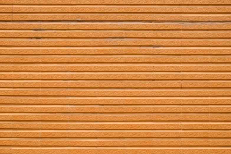 orange metal garage door with no windows on an urban building