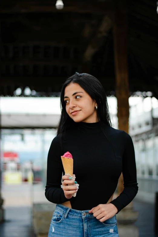 a woman is holding an ice cream cone