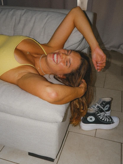 a woman laying on the floor in a yellow dress