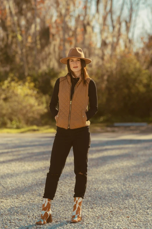 a woman is standing on the side of a road