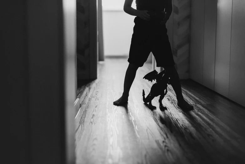 a woman holding an umbrella while standing on a hard wood floor