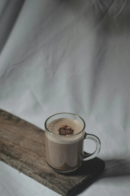 coffee in a glass cup sitting on a tray