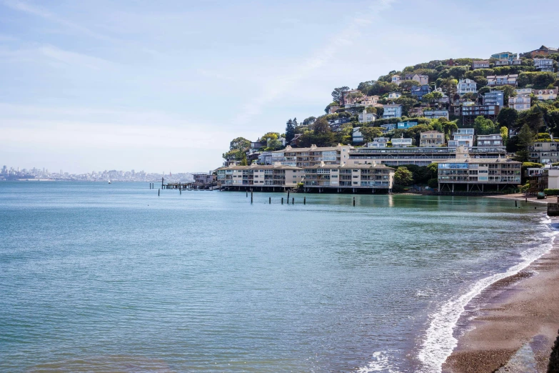 a large body of water with some houses next to it