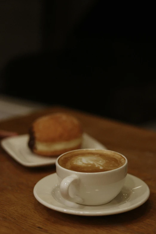 a coffee cup with some cinnamon rolls on the side