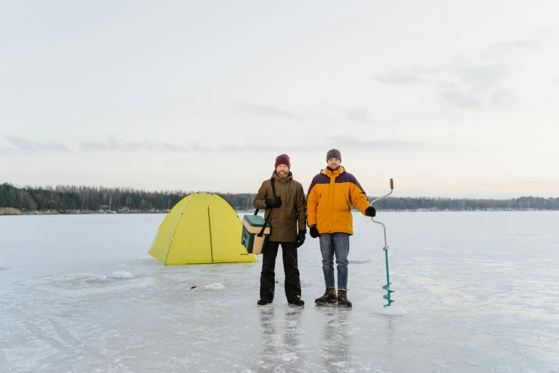 two people in jackets are standing on the ice