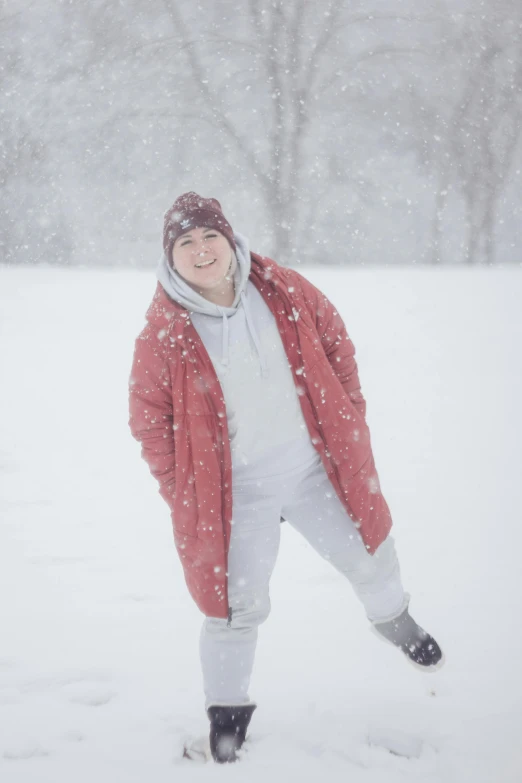 a woman standing on top of a snow covered field