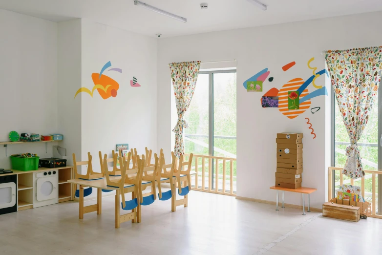 a white room with tables and chairs with a painting on the wall