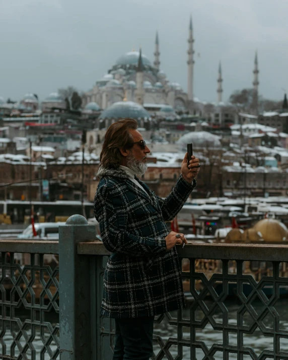 a woman taking a picture of an old city