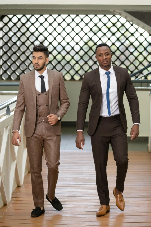 two well dressed men walking on a platform together