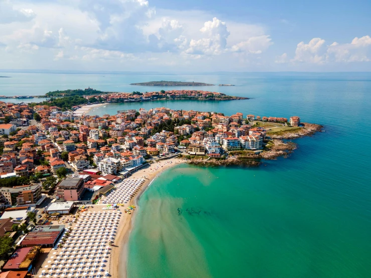 a view of a beach town next to the ocean