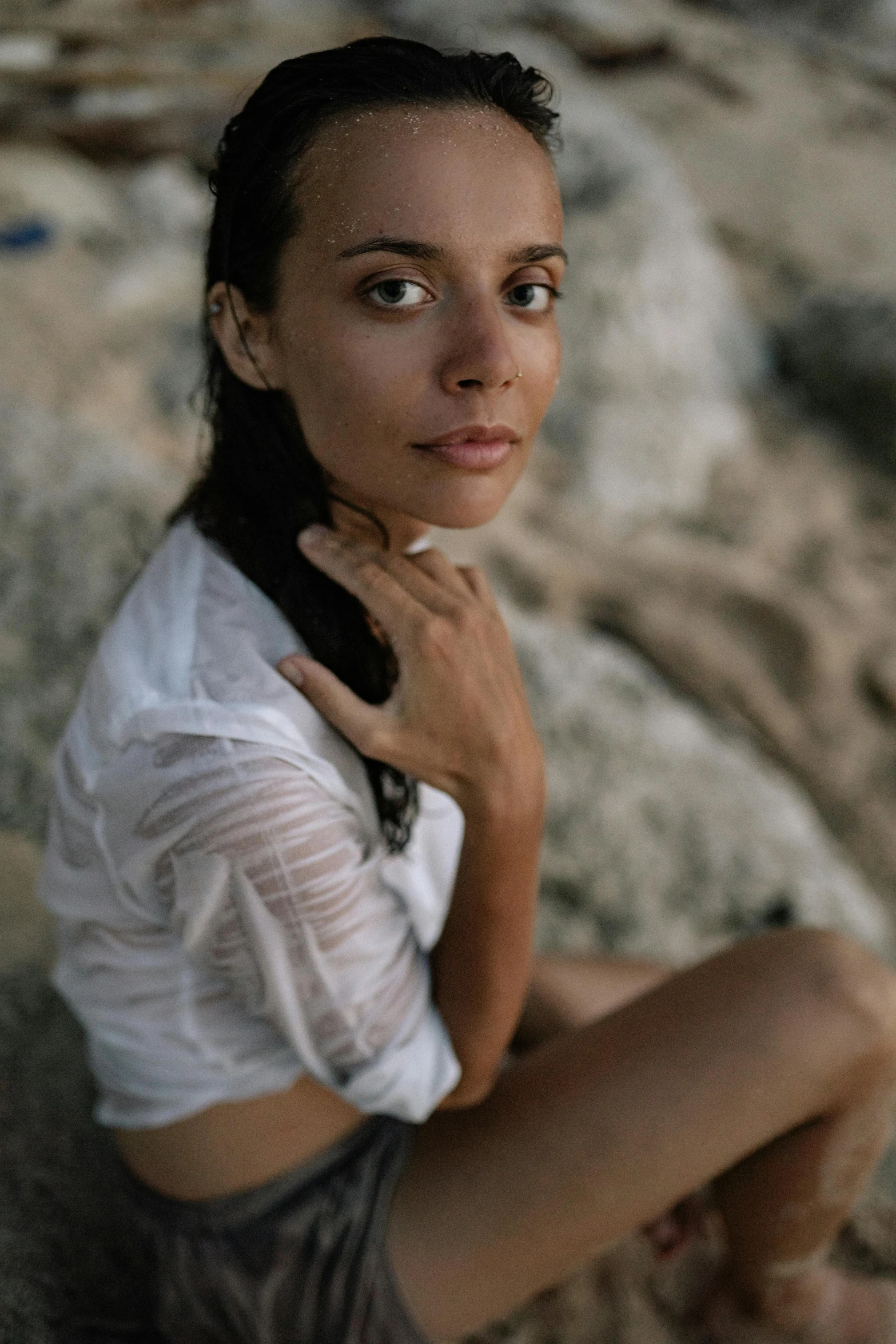 a young woman with brown hair sitting down