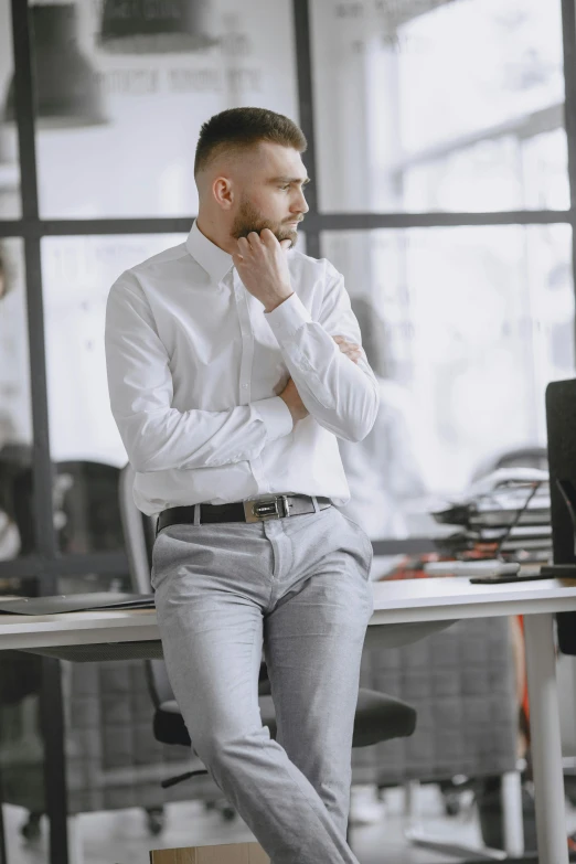 a man is sitting down with his hands clasped over his face