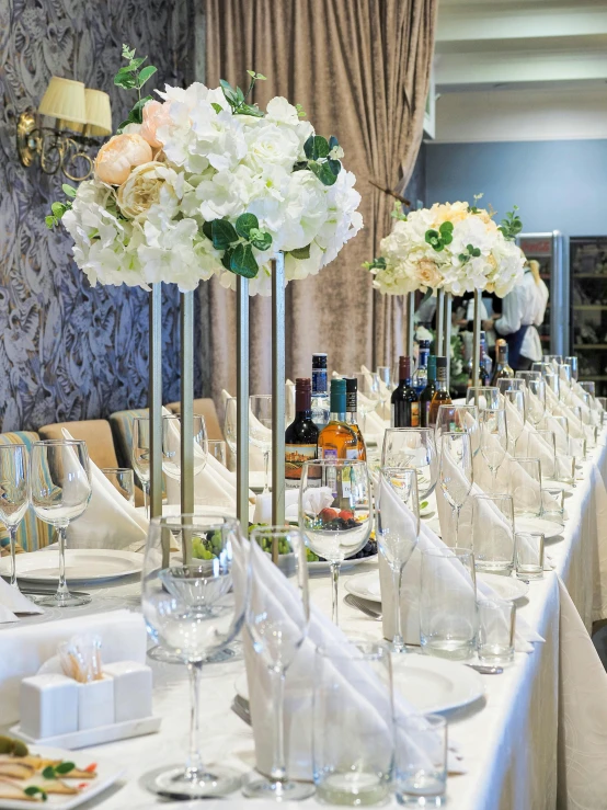 table set up with flower centerpieces and wine glasses