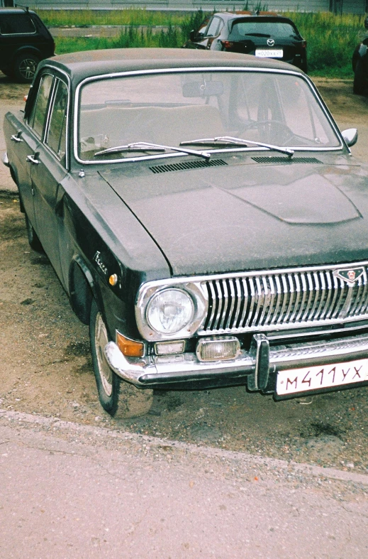 the old car is parked near another vehicle