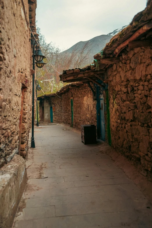 a narrow street with stone buildings on either side