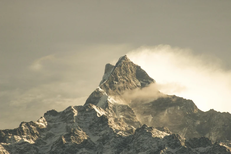 an image of a mountain that is very cloudy