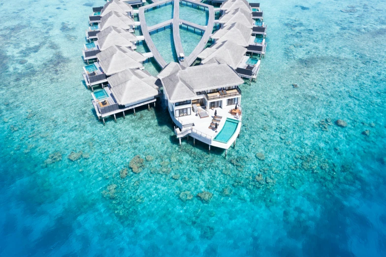 an aerial view of a boat with over water huts