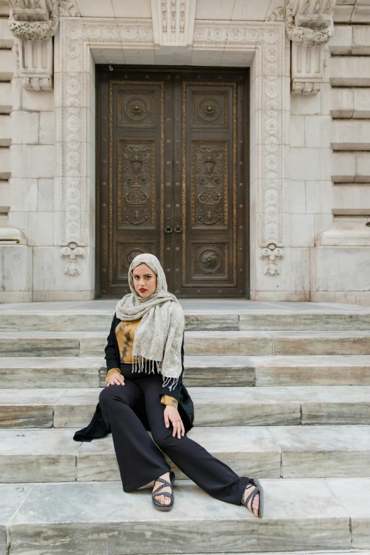 a woman sitting on the steps with a bag of food in front of her