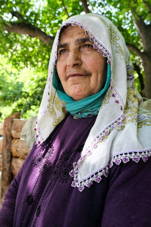 a very old lady wearing a scarf on her head