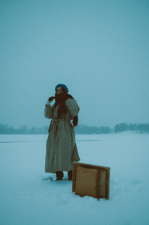 an old fashioned woman is standing in the snow