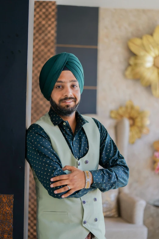 a man with his arms crossed and wearing a turban