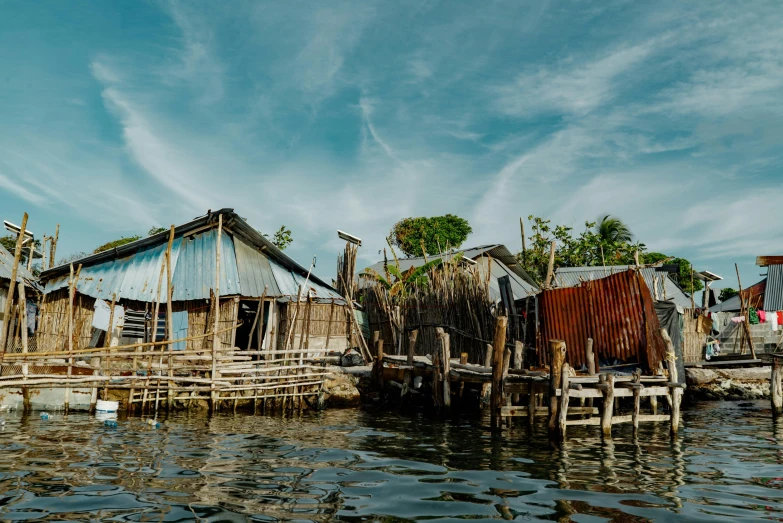 a group of small houses sit on a wooden pier