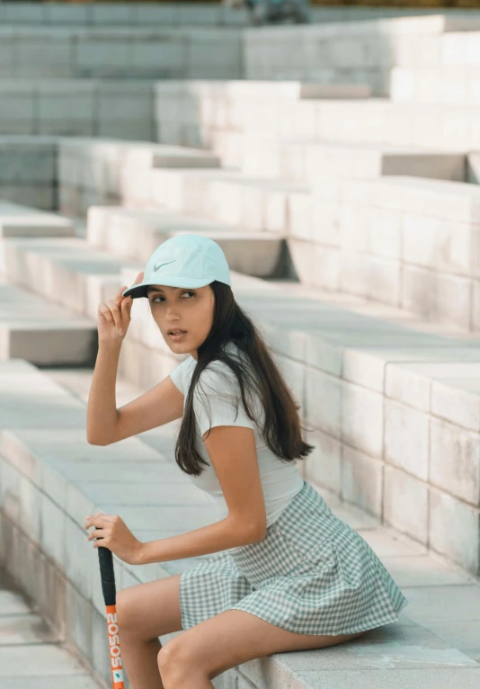 a  sitting on steps with a baseball bat