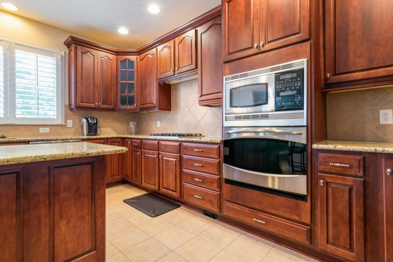 a very nice kitchen with granite countertops and wood cabinets