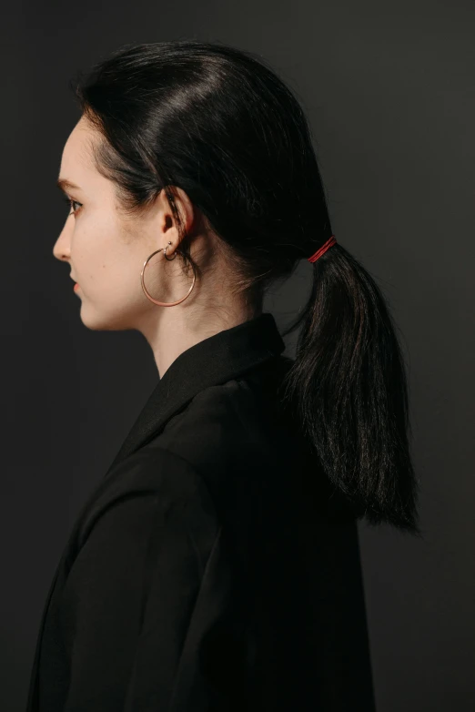 a young woman in a ponytail has a black shirt