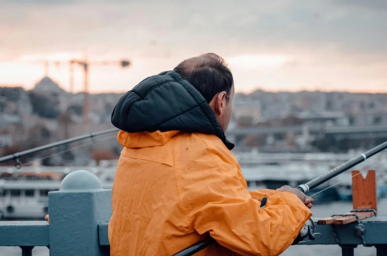 a man standing on a boat holding fishing rods