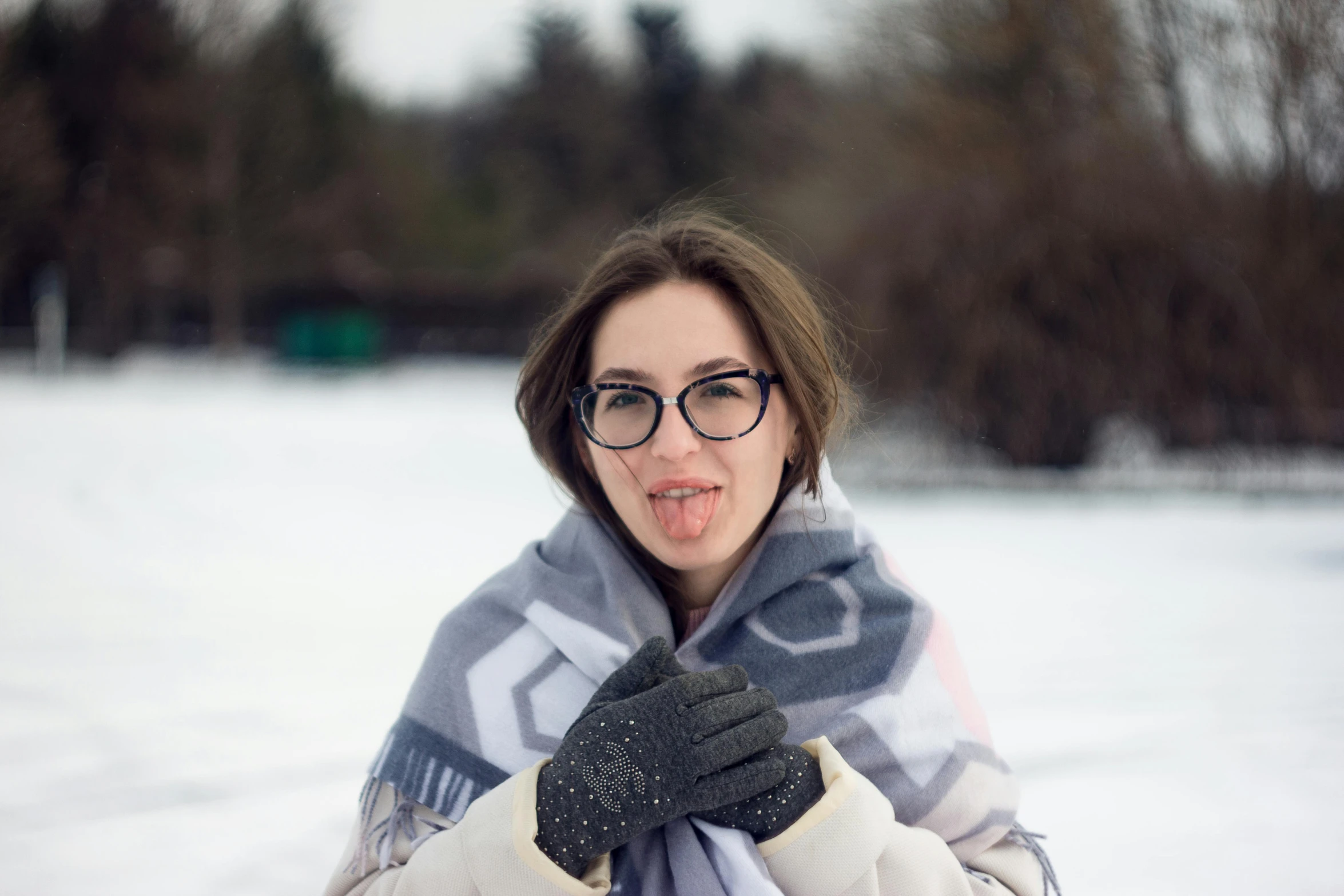 woman in a scarf and gloves looking up