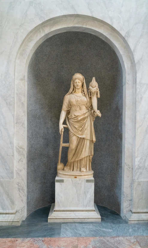 a statue of a woman holding a jug and a bird