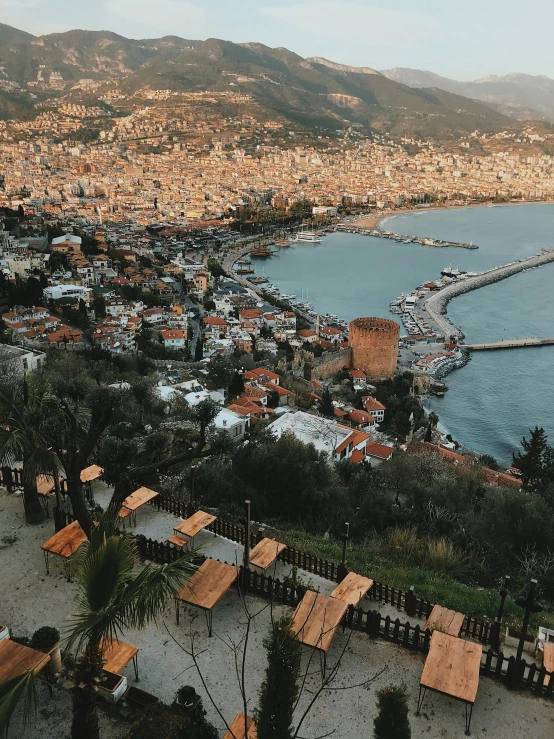 some buildings sitting on top of a hill next to a river