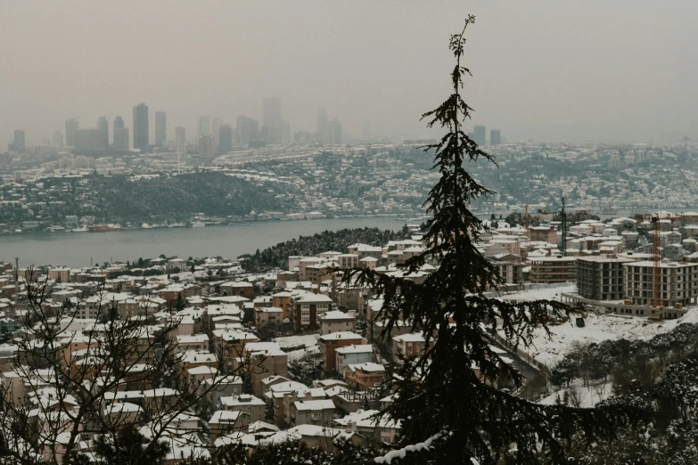 a snowy city view of the river and buildings