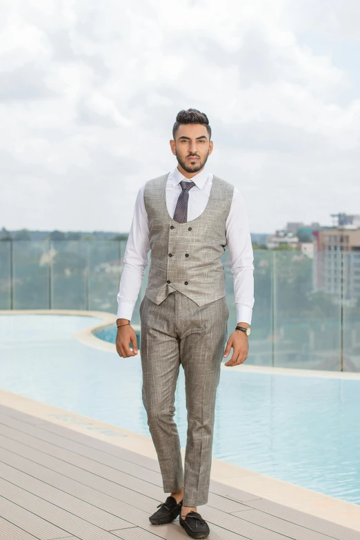 a man standing on a roof, in a suit and tie