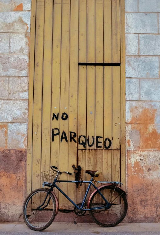 there is a bike parked next to the building