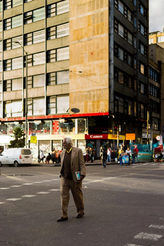 a person in an intersection with tall buildings