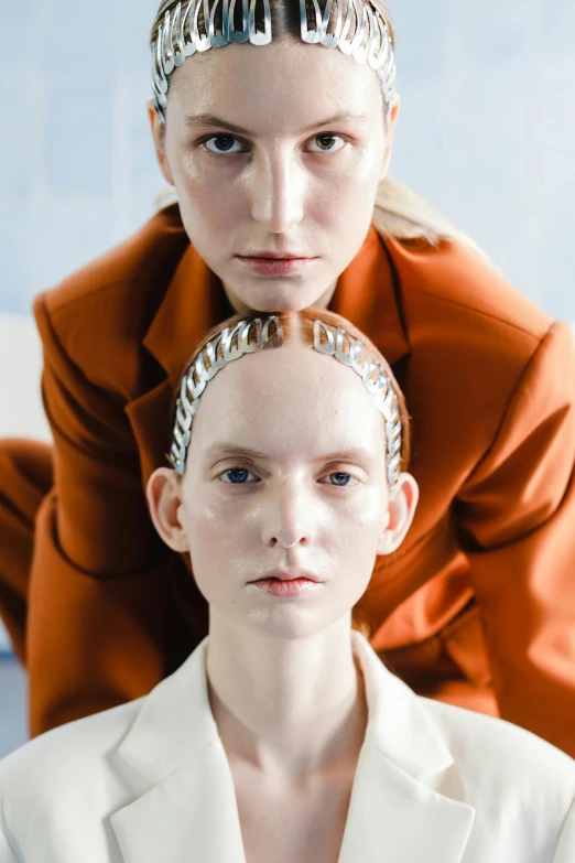 a model and another model with silver hair accessories